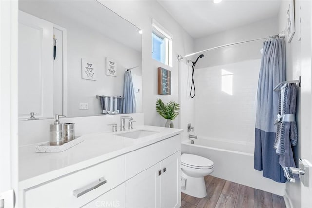 full bathroom with toilet, wood-type flooring, shower / bathtub combination with curtain, and vanity