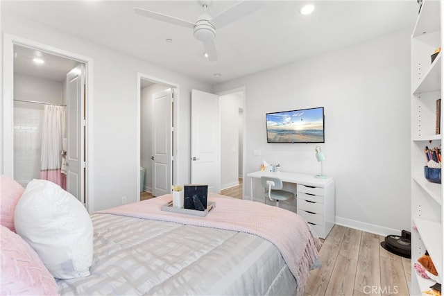 bedroom featuring ceiling fan, ensuite bathroom, and light hardwood / wood-style flooring