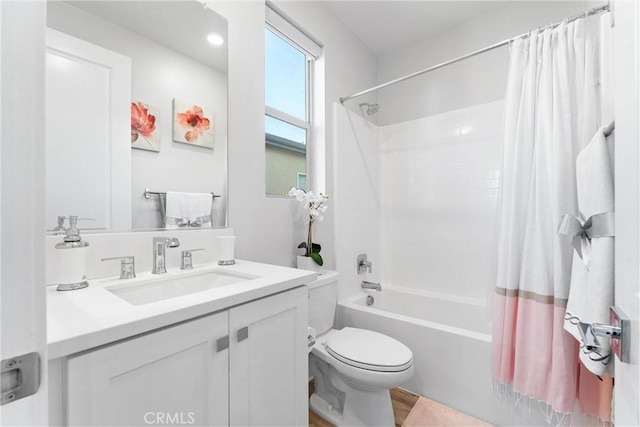 full bathroom featuring vanity, shower / bath combination with curtain, and toilet