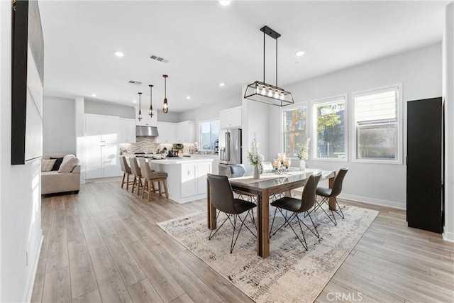 dining area with light hardwood / wood-style floors