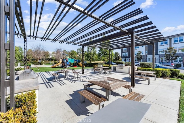 view of patio / terrace featuring area for grilling, a pergola, and a playground