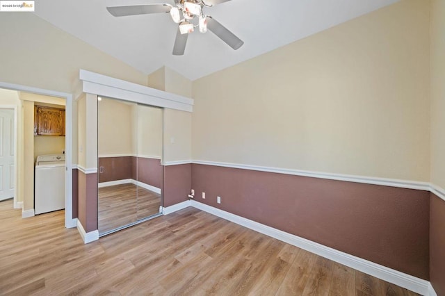 unfurnished bedroom with vaulted ceiling, a closet, washer / dryer, ceiling fan, and light hardwood / wood-style flooring