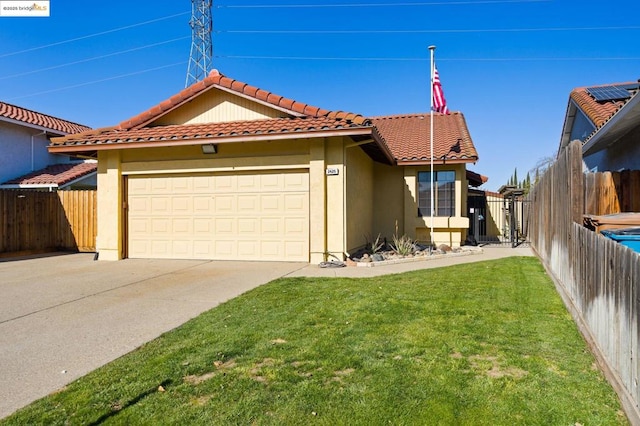 view of front of house featuring a garage and a front lawn