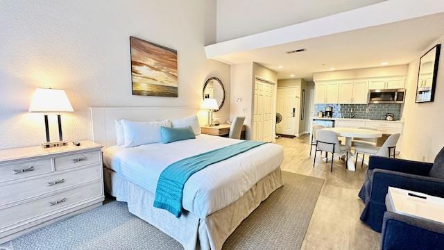 bedroom featuring light hardwood / wood-style floors and a closet