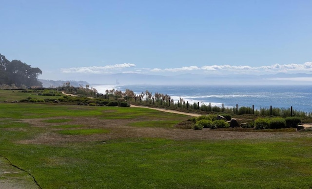 view of property's community with a water view and a lawn