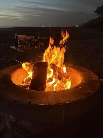 exterior details featuring an outdoor fire pit