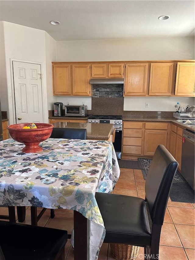 kitchen featuring appliances with stainless steel finishes, sink, and light tile patterned floors