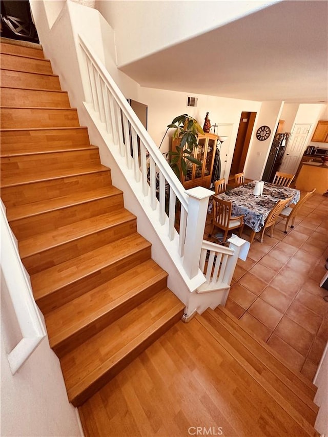 stairs featuring wood-type flooring