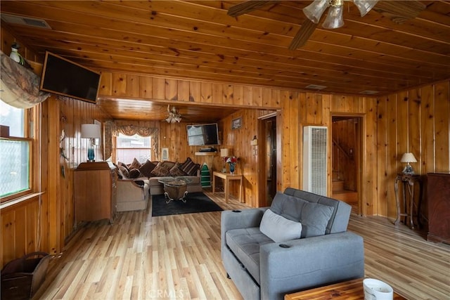 living room with a wealth of natural light, wooden ceiling, and ceiling fan