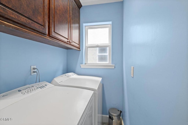 washroom with cabinets and washing machine and clothes dryer