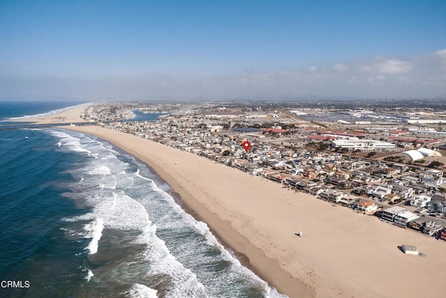 birds eye view of property with a view of the beach and a water view