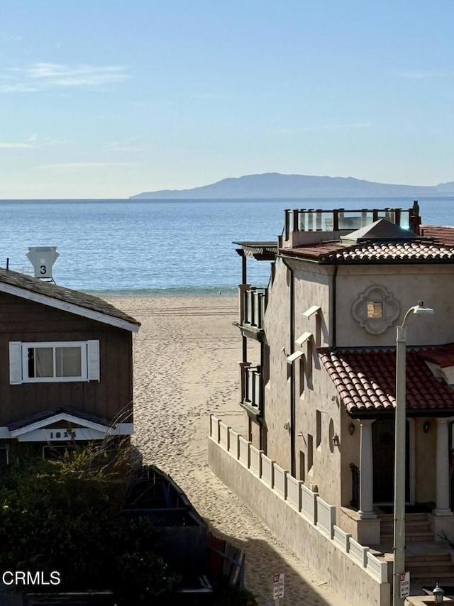 view of water feature featuring a view of the beach and a mountain view