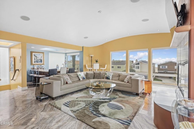 living room with lofted ceiling and a healthy amount of sunlight