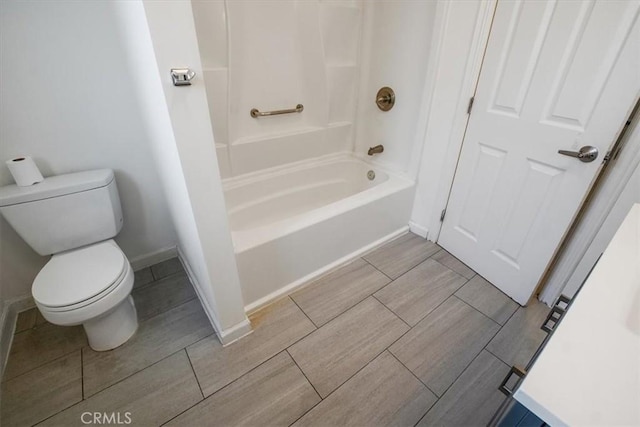 bathroom with bathtub / shower combination and toilet