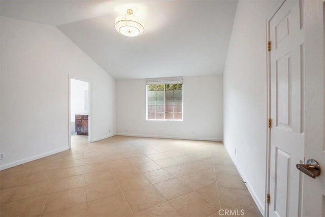 spare room featuring vaulted ceiling