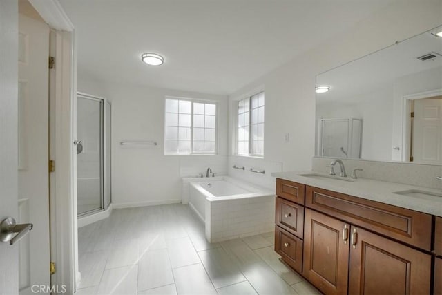 bathroom with vanity, tile patterned floors, and shower with separate bathtub