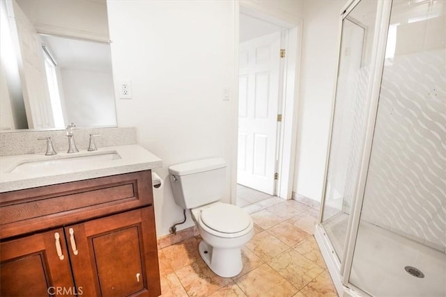 bathroom featuring vanity, an enclosed shower, and toilet