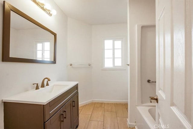 bathroom with washtub / shower combination and vanity