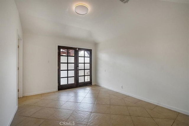 unfurnished room with french doors and lofted ceiling