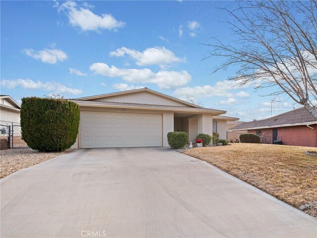 ranch-style house featuring a garage and a front yard