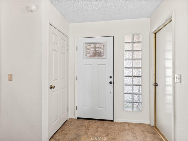 foyer featuring a healthy amount of sunlight and a textured ceiling