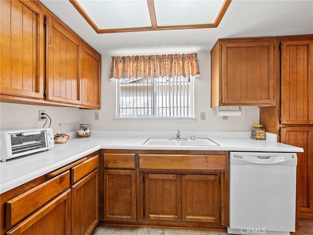 kitchen featuring white dishwasher and sink