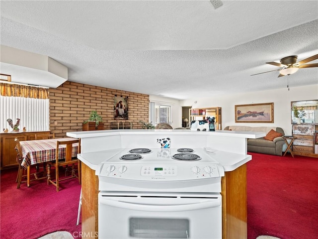 kitchen featuring ceiling fan, carpet flooring, white electric range oven, and a textured ceiling