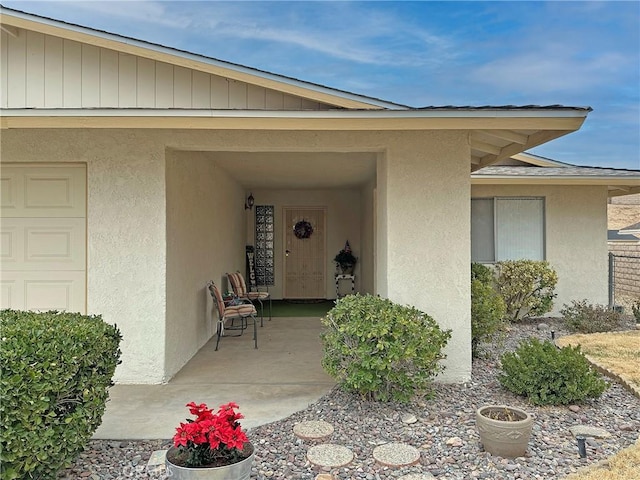 view of exterior entry featuring a patio