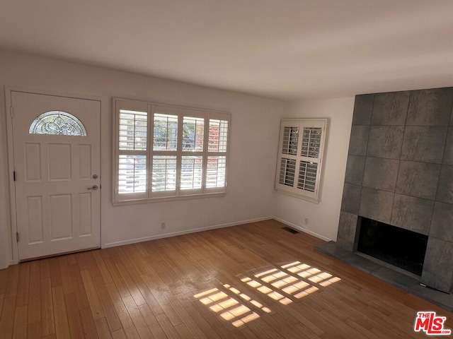 foyer featuring a fireplace and light hardwood / wood-style floors