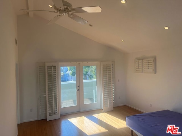 unfurnished bedroom with lofted ceiling, access to exterior, light wood-type flooring, and french doors