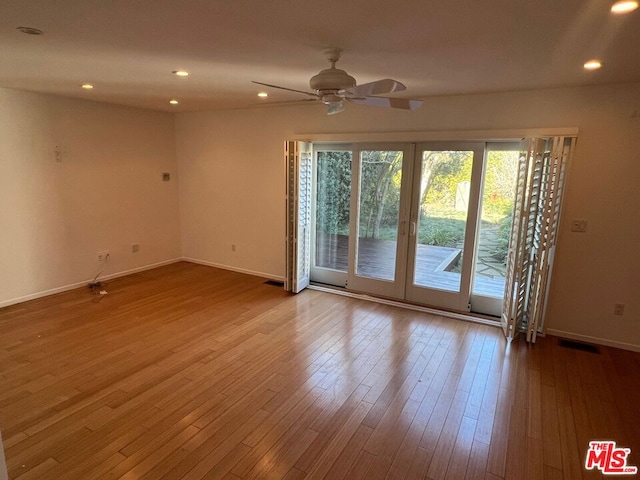 unfurnished room featuring light hardwood / wood-style floors and ceiling fan