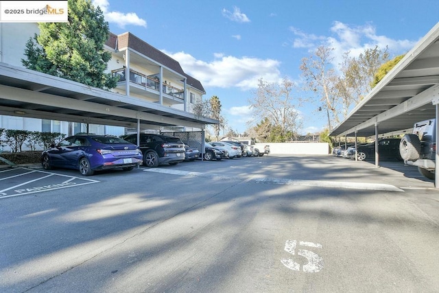 view of parking / parking lot featuring a carport