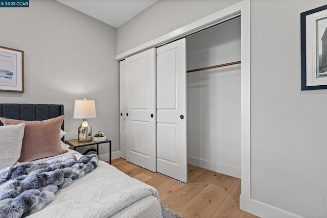 bedroom featuring hardwood / wood-style flooring and a closet