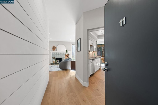 hall with sink and light hardwood / wood-style flooring