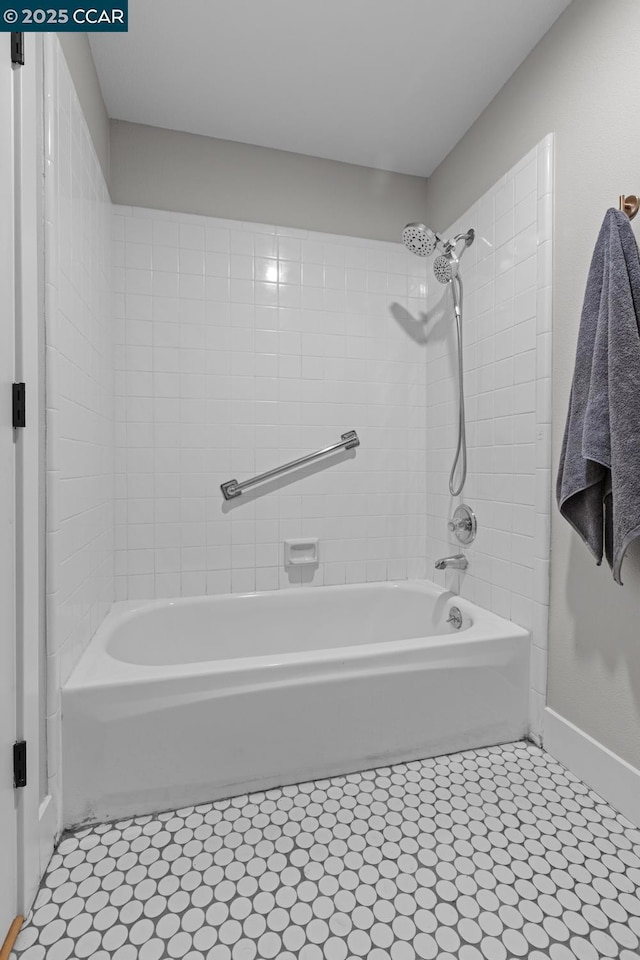 bathroom featuring tile patterned flooring and tiled shower / bath