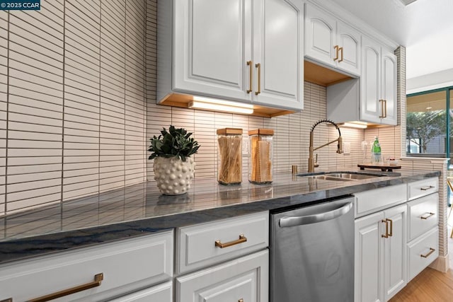 kitchen with white cabinetry, sink, and stainless steel dishwasher