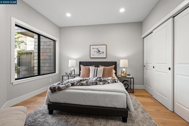 bedroom featuring a closet and light wood-type flooring