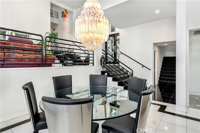 tiled dining space with a chandelier