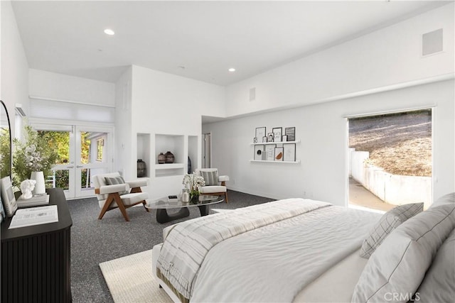 carpeted bedroom with a high ceiling