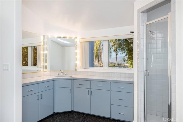 bathroom with lofted ceiling, a shower with shower door, and vanity