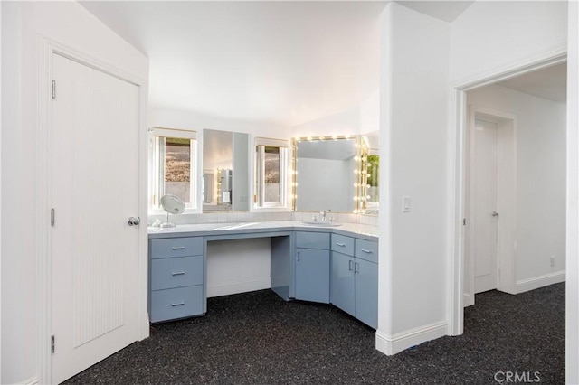 bathroom with lofted ceiling and vanity