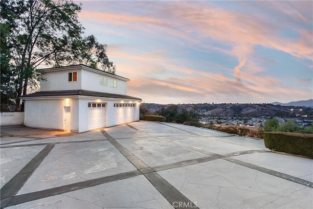 garage at dusk with a mountain view