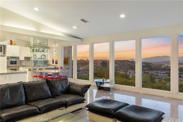 living room featuring vaulted ceiling and a mountain view