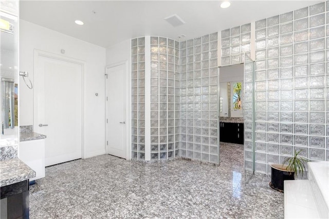 bathroom with tile walls