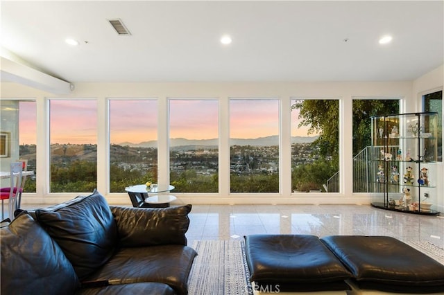 sunroom / solarium featuring a mountain view