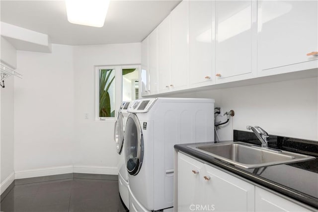 laundry room with cabinets, sink, and washing machine and dryer