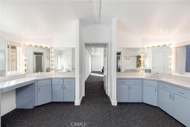 bathroom featuring vanity and lofted ceiling with beams