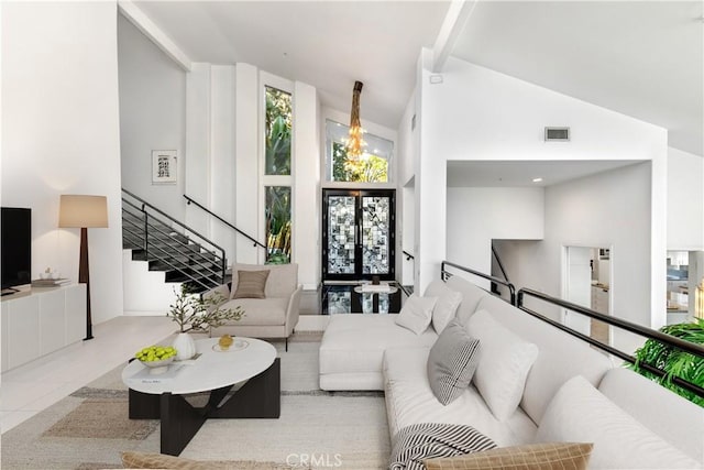 living room with high vaulted ceiling and french doors