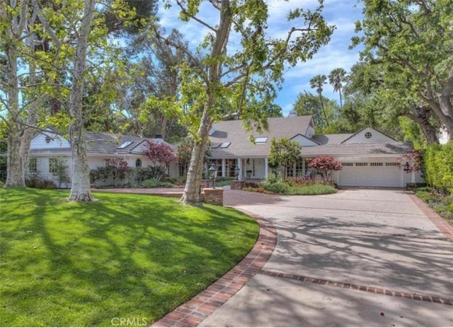 ranch-style home featuring a garage and a front yard