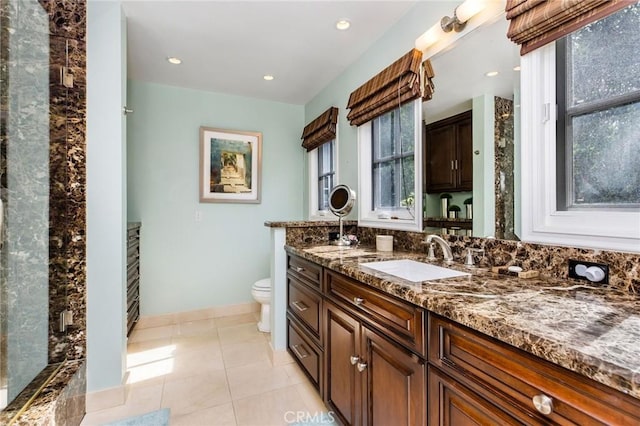 bathroom with vanity, tile patterned floors, and toilet